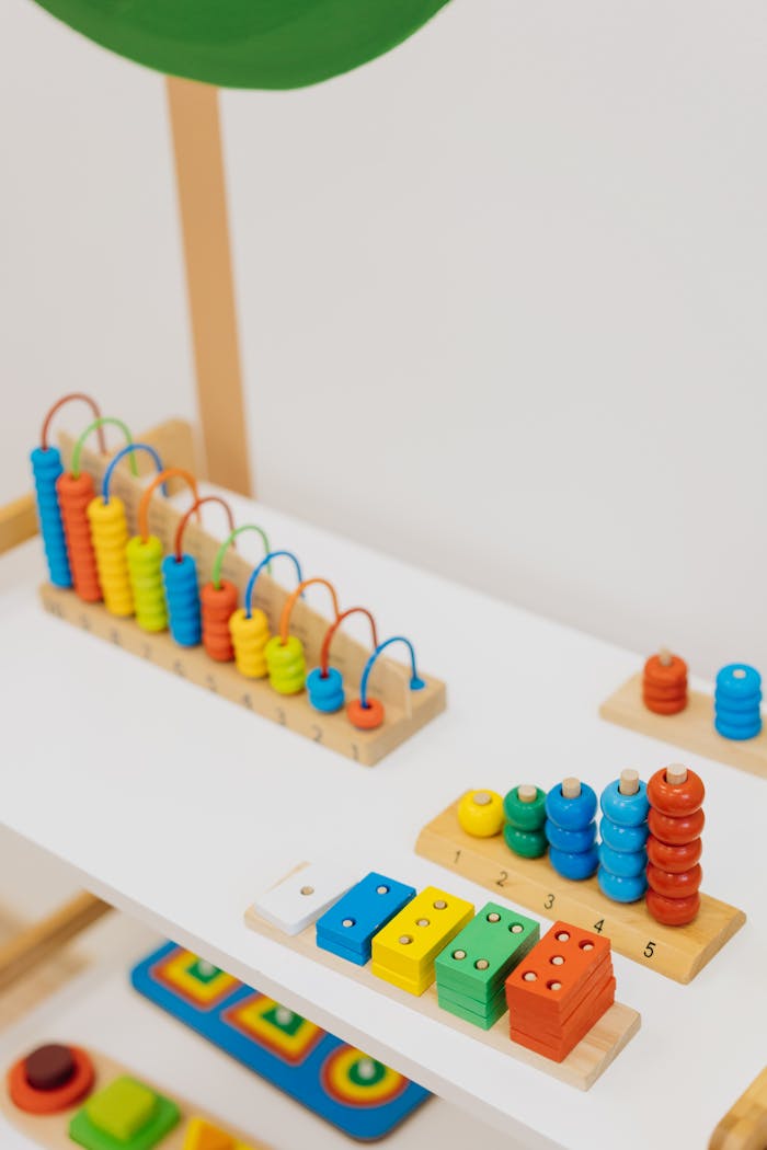 Services Bright and colorful wooden educational toys displayed on a shelf for learning.